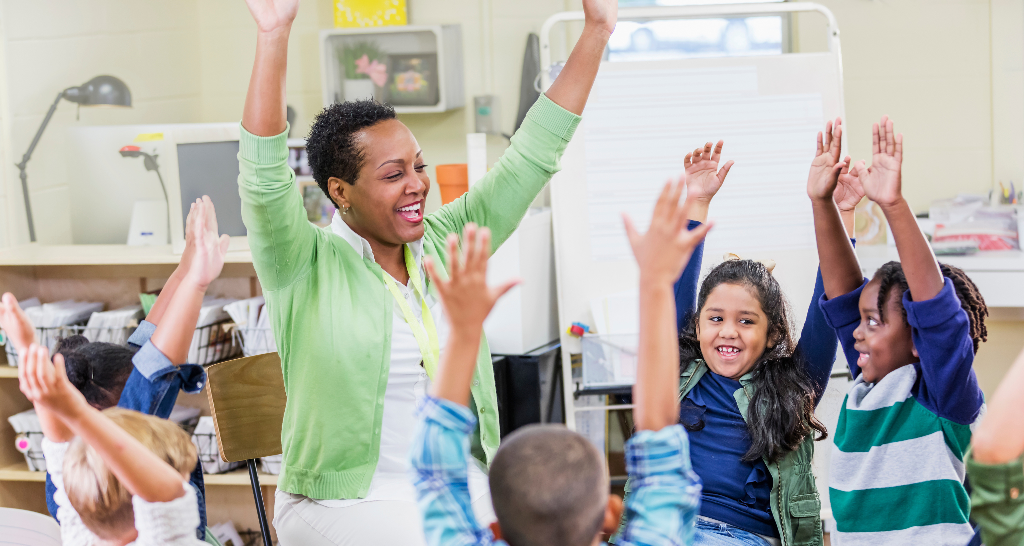 African-American teacher, young children in class